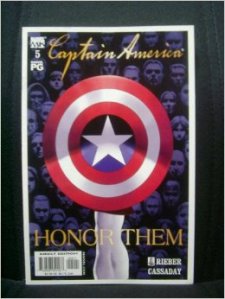 {Image is a scan of a comic book cover. Captain America's shield takes up most of the page. Faces of various men and women are in the background. Gold script at the top of the page reads, 